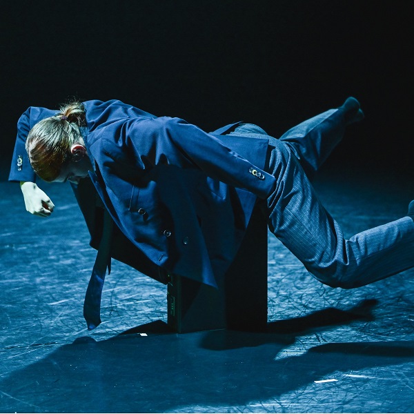 dancer appearing to float on a breifcase 