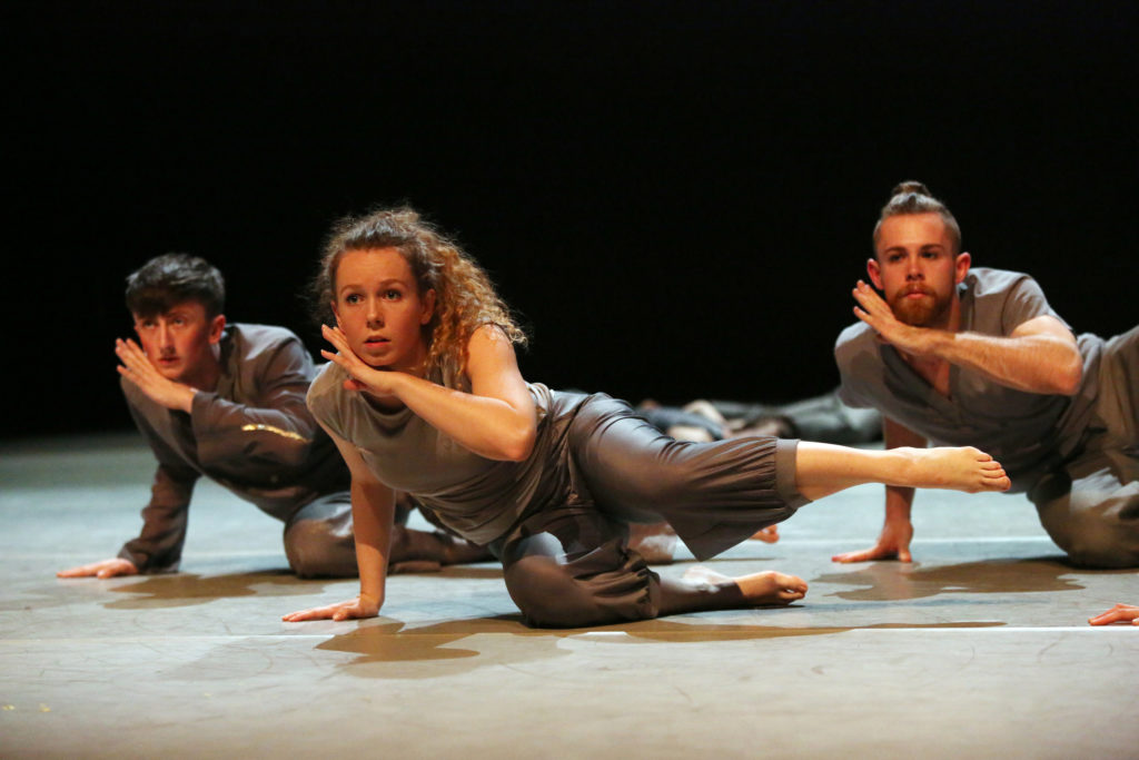 Osian and two other perfomers of transitions company in grey silver costumes