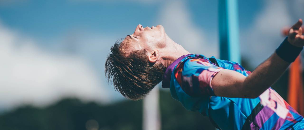 Tim head leaning back against a blue sky