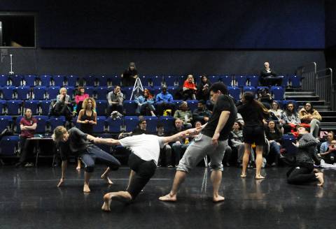 Dances rehearsing in a studio with audience watching