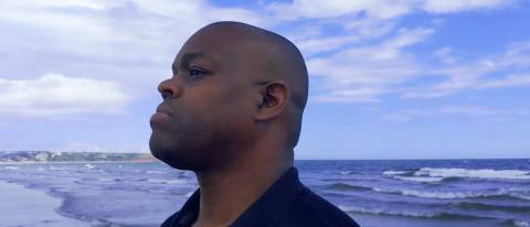 Marvin standing against the ocean