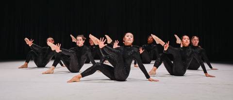Dancers on floor with sparkling black costumes