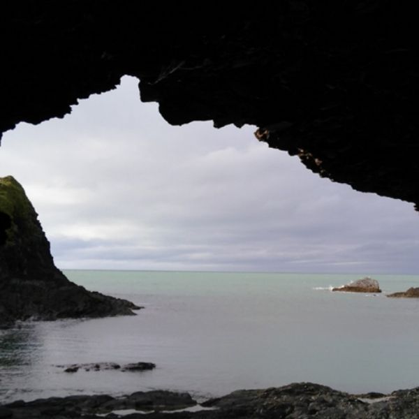 in a cave looking out at the sea