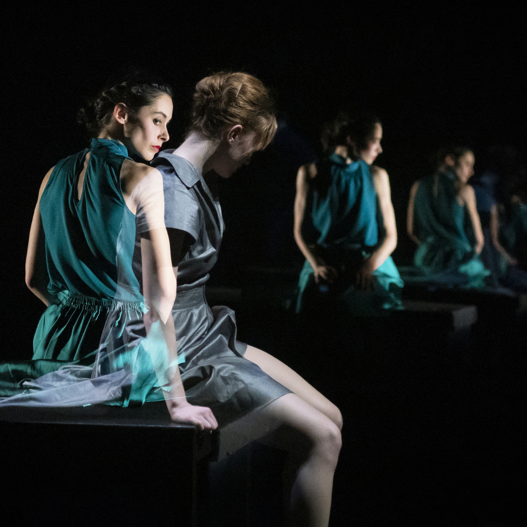 a girl in a green dress reflected over and over