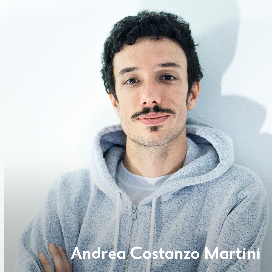 Andrea Costanzo Martini has black hair and mustache and wears a grey hoodie