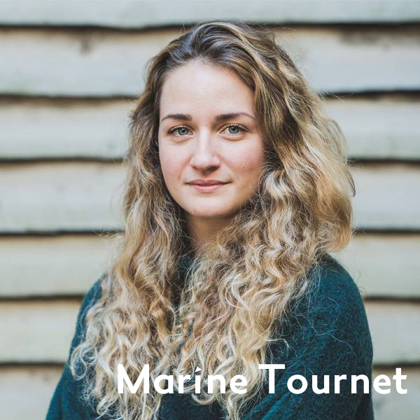 Marine with long curled hair and a green jumper
