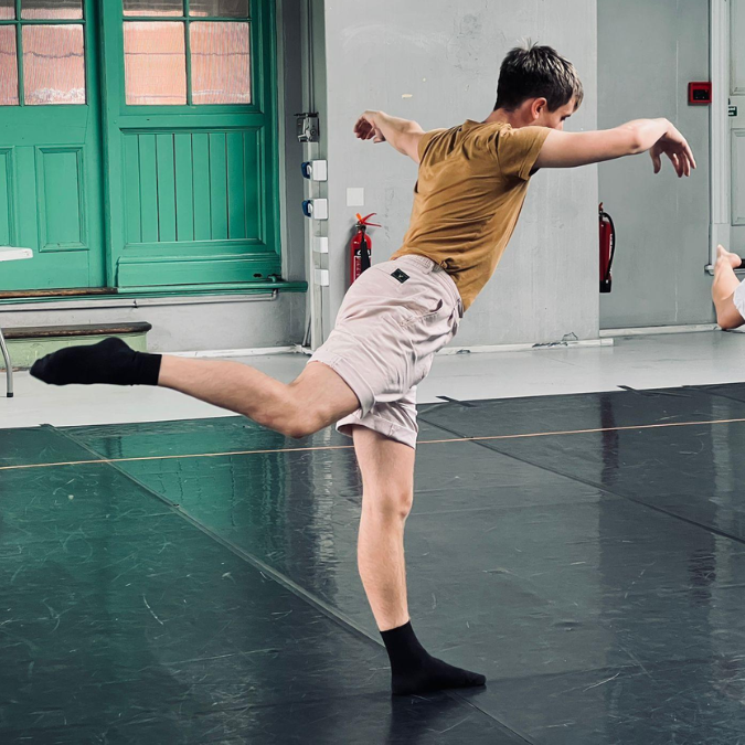 mei dancing in a light airy green studio