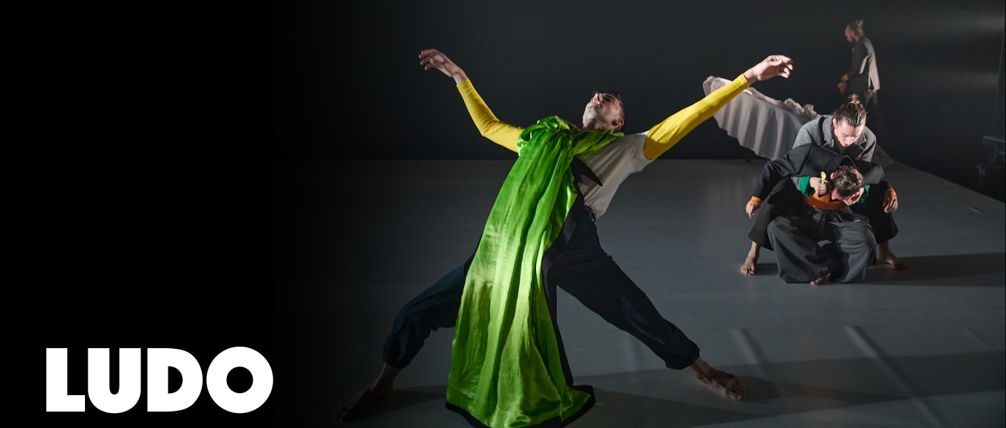 a dancer in a green dress leans backwards dramatically 