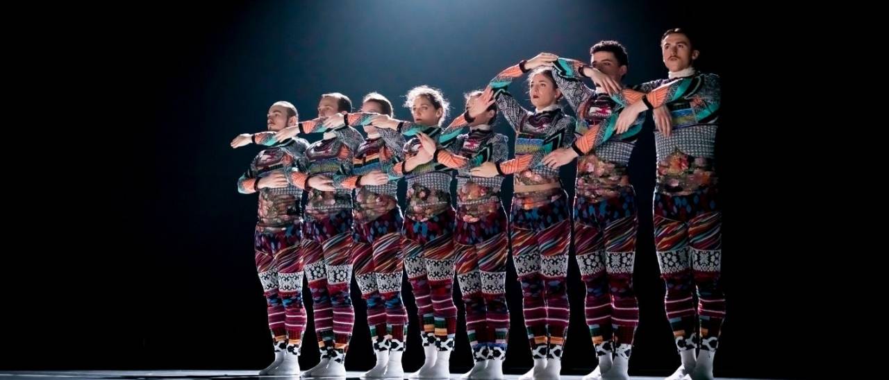 Tundra image, dancers in a line arms joined up