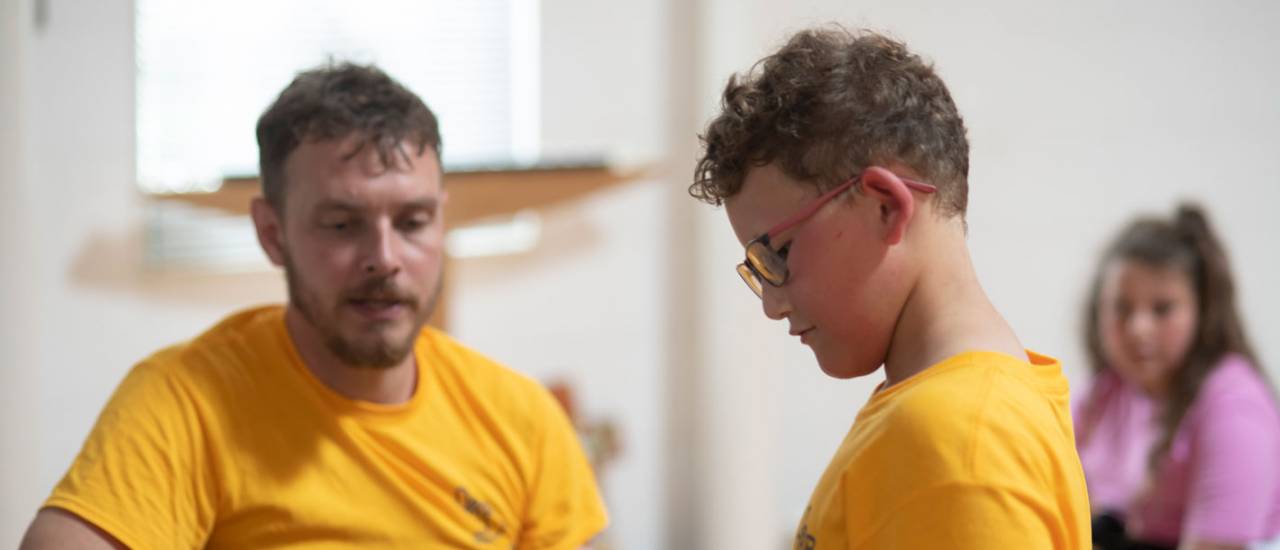 young boy and man in yellow tshirts