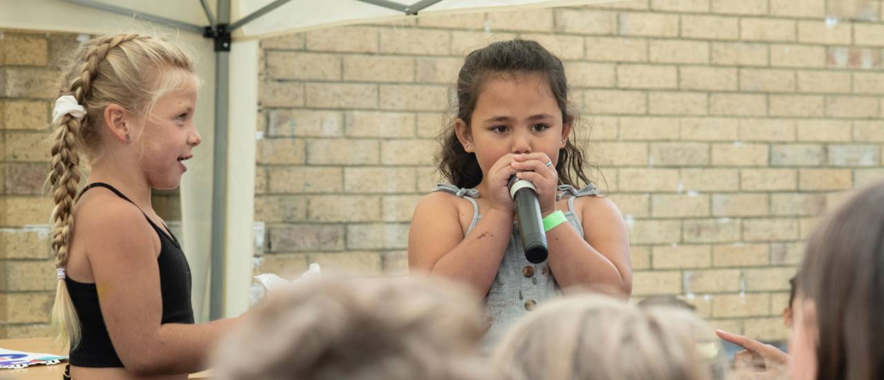 young girl speaking in to mic