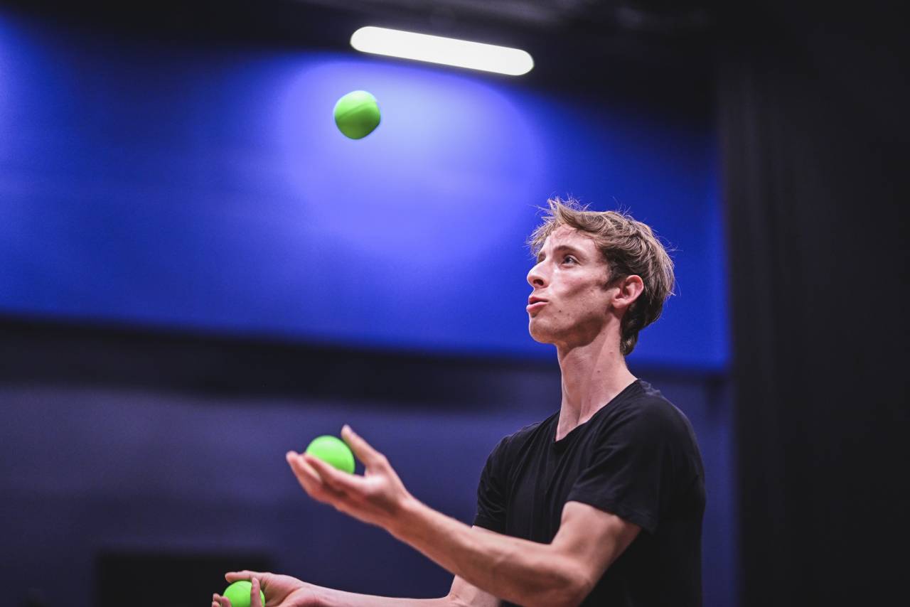 sam is learning to juggle with green balls