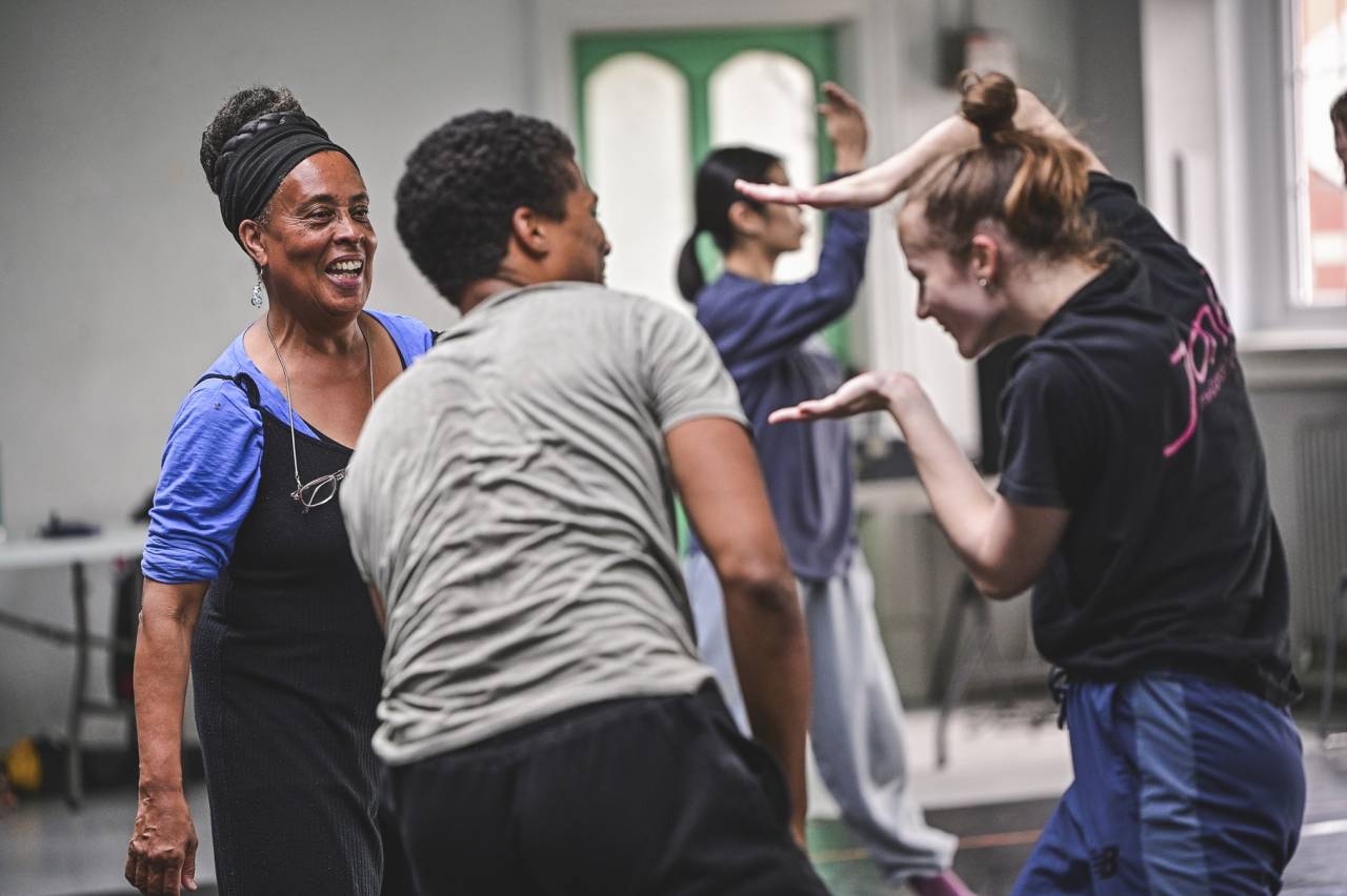 June and dancers laughing in studio