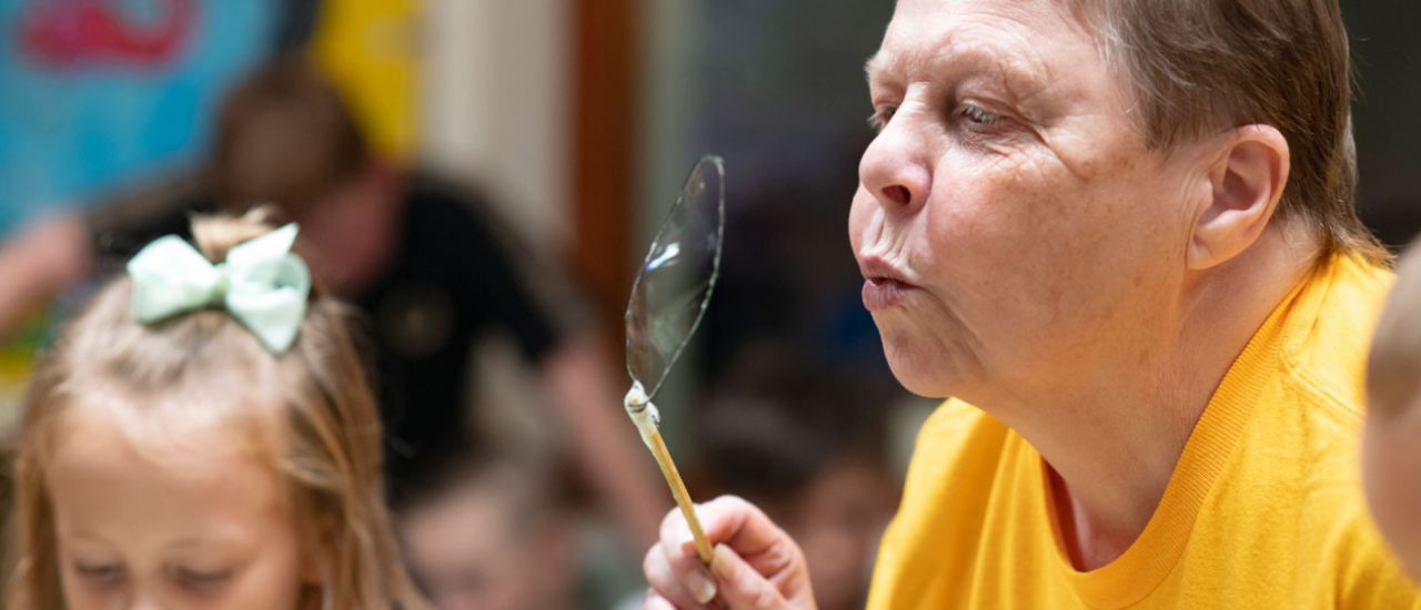 volunteer blowing bubbles