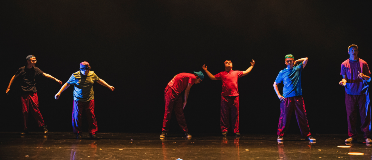 young dancers in bright colourful retro clothing and backwards caps