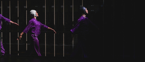 Three dancers in purple satin costumes and sparkling swim caps march perfect harmony