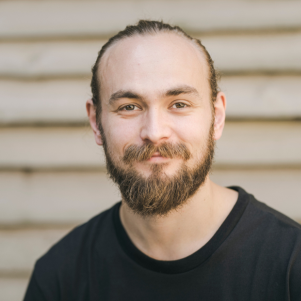 Ed Myhill has long blonde hair pulled back into a bun, a full beard and a kind smile